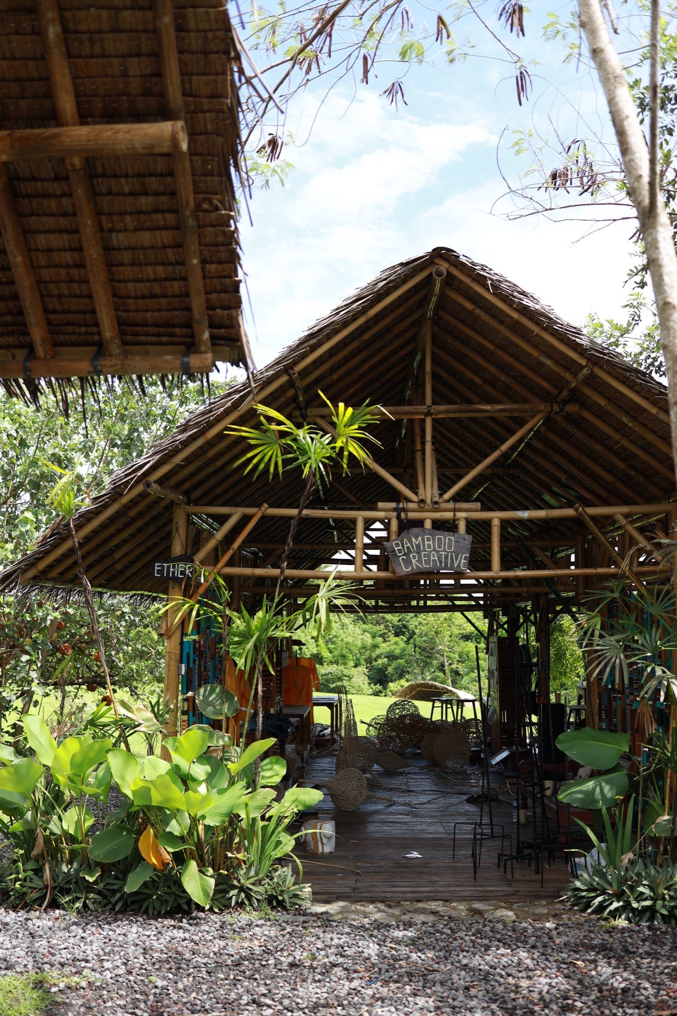 The Bamboo Creative pavilion at Art Village, surrounded by tropical plants